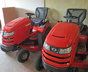 Two red lawn tractors