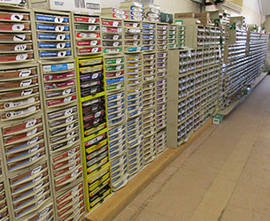 A row of drawers labeled with hardware parts