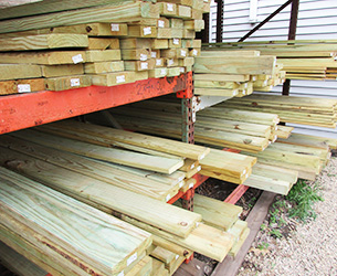 An outdoor rack of lumber in various sizes
